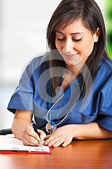 Nurse writing prescription