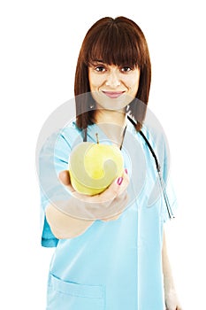 Nurse or young doctor giving an apple smiling