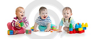 Nursery babies playing with color toys isolated on white background