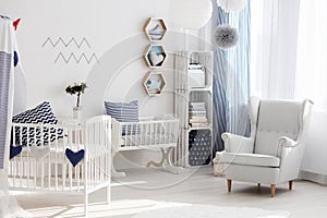 Nursery with white chair and cradle photo
