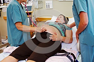 Nurses admitting maternity patient to hospital