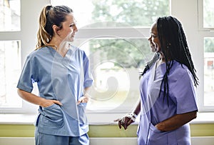 Nurses having a conversation in the hospital hallway