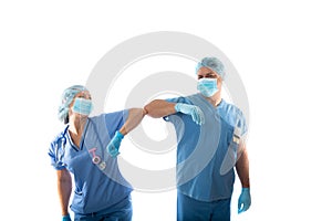 Nurses in scrubs elbow bump instead of shaking hands during COVID-19 pandemic