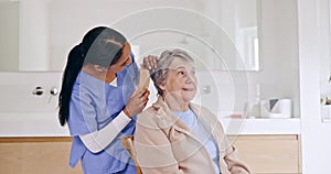 Nursing home, grooming and caregiver brushing hair of senior woman with care, love and kindness in a bathroom. Assisted