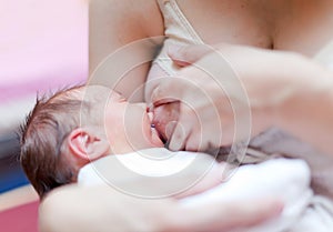 Nursing newborn baby