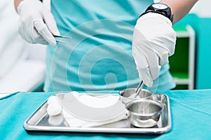 Nursing student prepare Sterile wound Kit for her patient. Closed-up to hand with soft focus. photo
