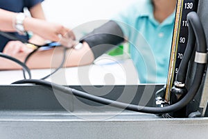 Nursing students are training measurement of blood pressure with manual sphygmomanometer and stethoscope at nursing school. photo