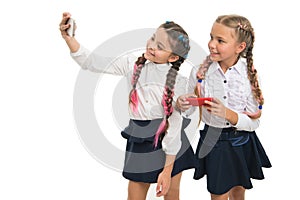 Nurturing your blog culture. Little schoolchildren making selfie for new blog isolated on white. Small bloggers keeping