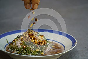Nusa Penida,Bali-Sept 04 2021: A Close up photo of the fresh seaweed on a plate. In Bali, its called bulungA Close up photo of the