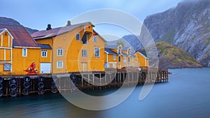 Nusfjord authentic fishing village with traditional yellow buildings. Lofoten islands, Norway. Blurred long exposure