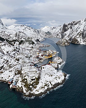 Nusfjord Fishing Village, Rorbu, Fjord and Mountains in Winter. Lofoten Islands, Norway. Aerial View