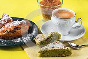 Nut cakes, cup of coffee, sugar on yellow background.