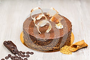 Nut chocolate cake with biscuits and nuts on the table