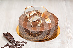 Nut chocolate cake with biscuits rings on the table