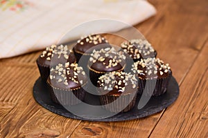 Nut-chocolate muffins covered with dark chocolate and nuts