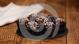 Nut-chocolate muffins covered with dark chocolate and nuts