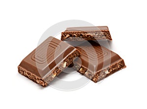 Nut chocolate squares over white background