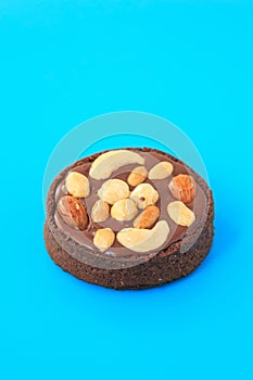 Nut chocolate tartlet on the blue background