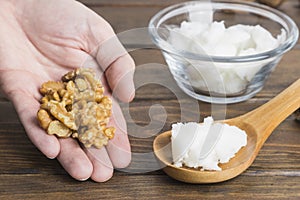 Nut cream in spoon on wooden background