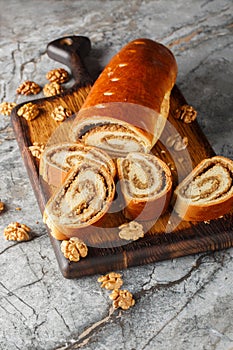 Nut roll is a pastry consisting of a sweet yeast dough with a nut paste made from ground nuts and honey closeup on the wooden