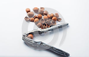 Nutcracker and hazelnuts on a white background