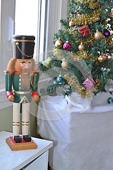 Nutcracker and small Christmas tree.