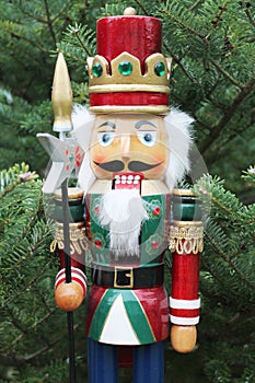 Nutcracker soldier and christmas tree as a background