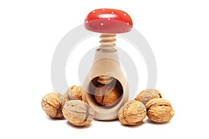 Nutcracker and walnuts isolated on white