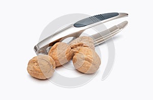 Nutcracker and walnuts on white