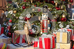 Nutcracker and wood horse at Christmas Market  in Winter Moscow, Russia. Advent Decoration and fir tree with Crafts gifts on the