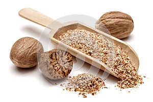 Nutmeg and granules in wooden scoop