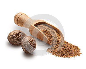 Nutmeg powder in a wooden scoop isolated on white