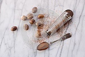 Nutmeg seeds with grater and spoon