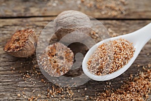 Nutmeg whole and grated on wooden table