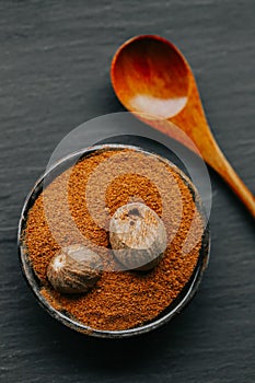 Nutmeg whole and ground.condiments and spices background.Nutmeg in a cut and nutmeg powder