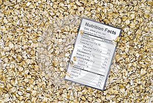 Nutrition facts of whole grain raw oats with oats background