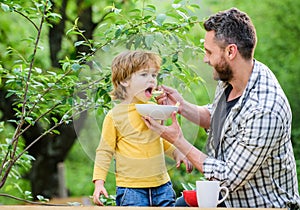 Nutrition habits. Little boy and dad eating. Nutrition for kids and adults. Healthy nutrition concept. Feeding baby