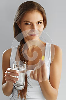 Nutrition. Healthy Lifestyle. Woman Holding Pill With Fish Oil O