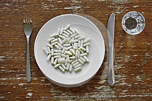 Nutrition supplement controversial pharmacy pills on plate photo