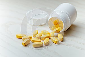 Nutrition supplements, yellow multivitamin pills photo