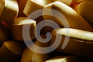 Nutritional supplements, lots of brown vitamin pills, concept medicine, background, macro