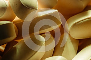 Nutritional supplements, lots of brown vitamin pills, concept medicine, background, macro