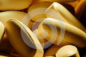 Nutritional supplements, lots of brown vitamin pills, concept medicine, background, macro