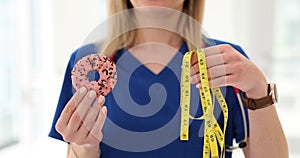 Nutritionist compares donut and measuring tape and discusses calorie intake and exercise