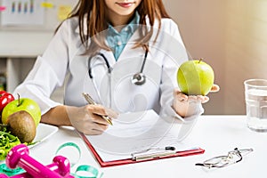 Nutritionist giving consultation to patient with healthy fruit and vegetable, Right nutrition and diet