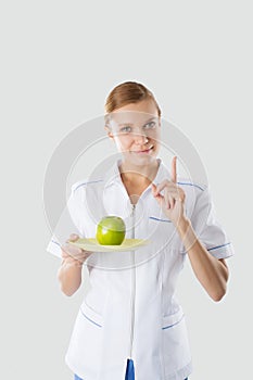Nutritionist holding hands green apple