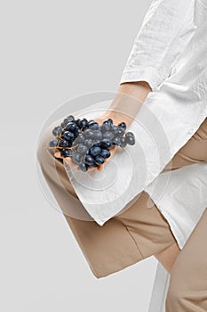 Nutritionist holds a bunch of grapes in her hand
