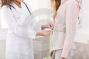 Nutritionist measuring bmi of patient in office