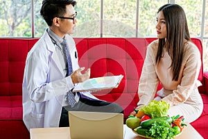 Nutritionist physician advised young female patient on  nutrition and healthy diet eating to prevent virus pandemic in clinical