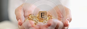 Nutritionist shows capsules of vitamin E or omega-3.